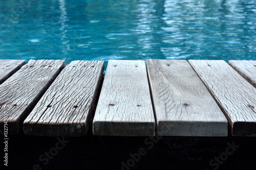 wooden walkway beside hotel pool.
