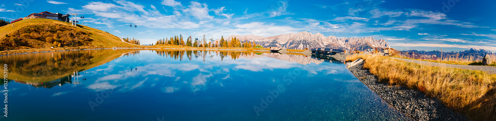 Fototapeta premium High resolution stitched alpine autumn or indian summer panorama with reflections at Mount Hartkaiser, Ellmau, Kufstein, Tyrol, Austria