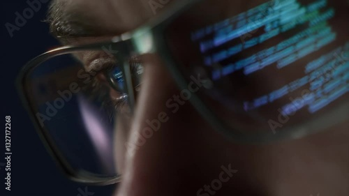Extreme close-up of a programmers eye with computer code reflecting on glasses, symbolizing cybersecurity, coding, and software development. 