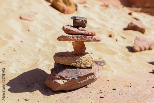 A tower made of flat stones, stacked on top of each other in the desert.