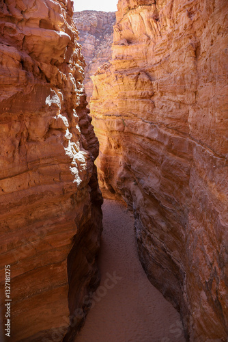 A top-down photo of a narrow canyon with high sandstone walls