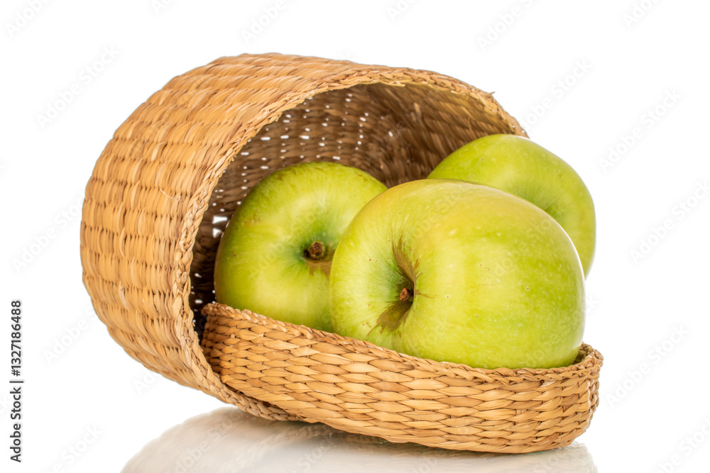 Several sweet green apples in a straw basket, close-up, isolated on a white background. Several sweet green apples in a straw basket, close-up, isolated on a white background.