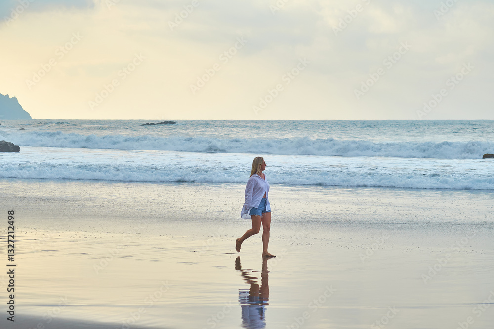 Woman Walking Along the Beach at Sunset. Waves, shore, relaxation, nature, and freedom. Woman Walking Along the Beach at Sunset. Waves, shore, relaxation, nature, and freedom.