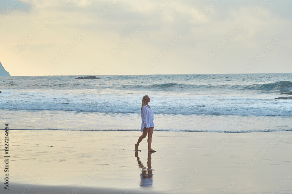 Woman Walking Along the Beach at Sunset. Waves, shore, relaxation, nature, and freedom. Woman Walking Along the Beach at Sunset. Waves, shore, relaxation, nature, and freedom.