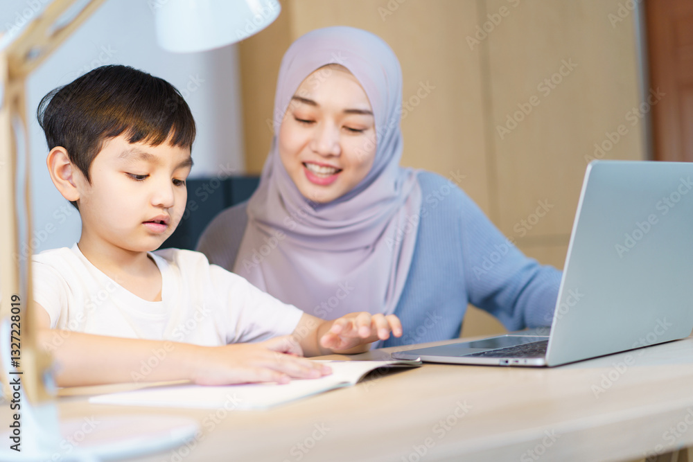 Asian muslim woman is teaching and reviewing homework with her daughter. Asian muslim woman is teaching and reviewing homework with her daughter.
