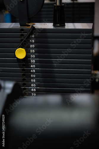 A black weight machine with yellow pin