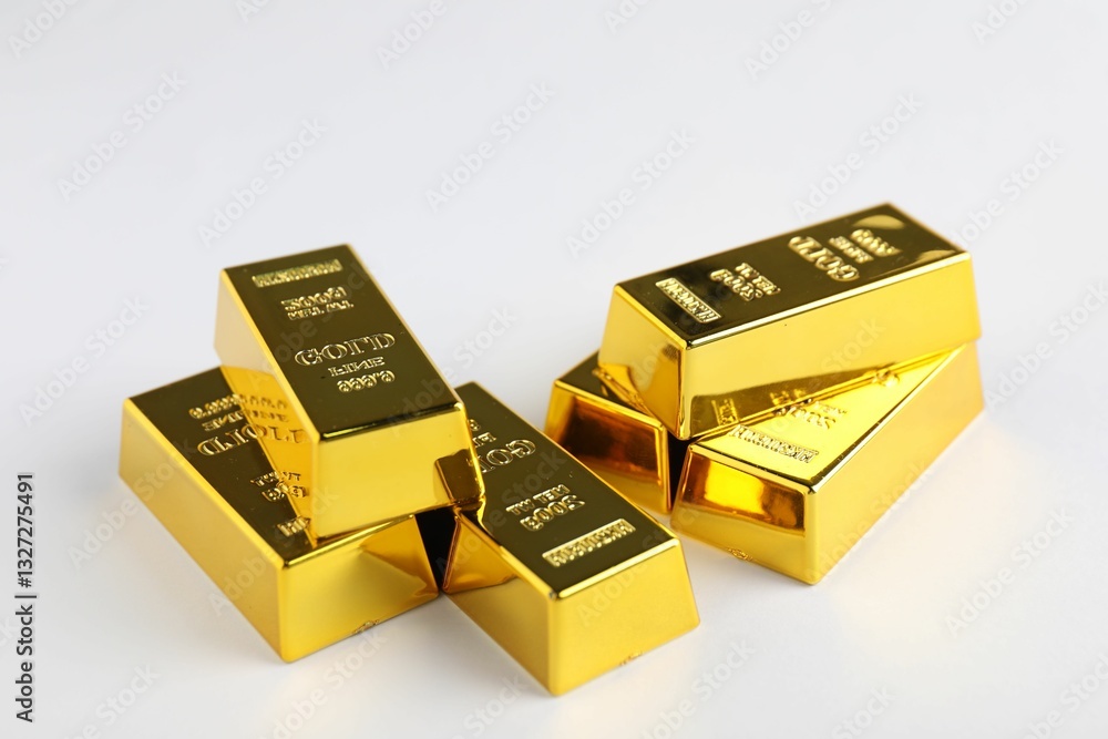 Shiny gold bars on white background, closeup Shiny gold bars on white background, closeup