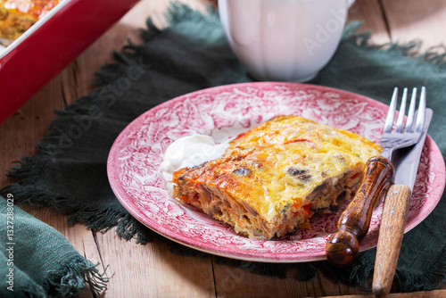 Obraz na płótnie Oven baked omelette with vegetables served with sour cream on wooden background. w salonie