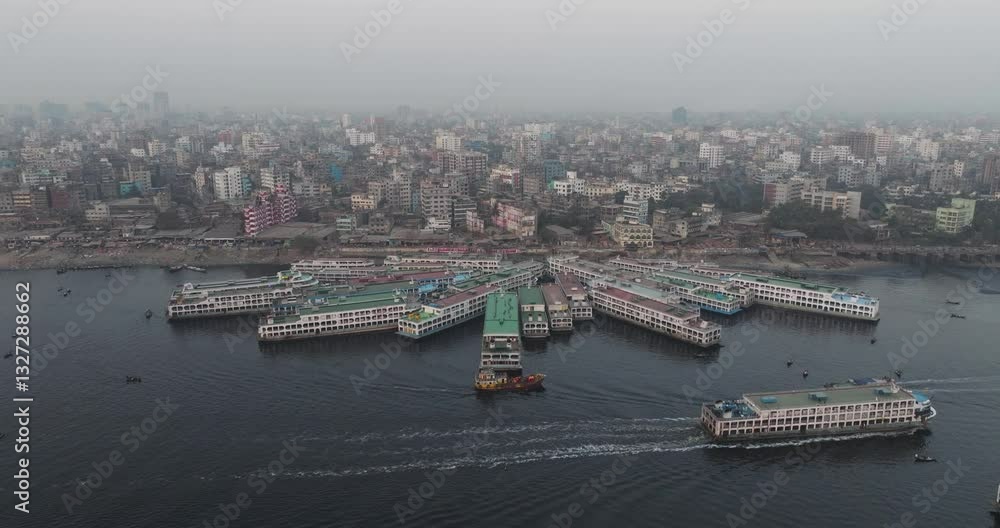 Aerial view of Sadar Ghat along the Buriganga river with beautiful boats and modern buildings, Dhaka, Dhaka Province, Bangladesh. Aerial view of Sadar Ghat along the Buriganga river with beautiful boats and modern buildings, Dhaka, Dhaka Province, Bangladesh.