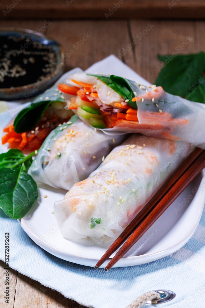 Summer or spring rolls with shrimp, vegetables and spinach, served with soy sauce and sesame. Traditional Vietnamese food.