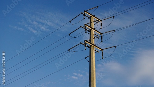 metallic electric tower against the blue sky