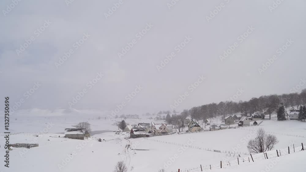 Small village at the edge of the forest under snowfall in winter Small village at the edge of the forest under snowfall in winter