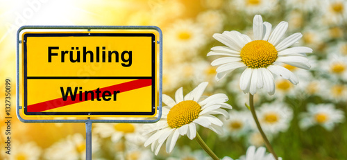 Obraz na płótnie Ein Ortsschild steht vor einer Blumenwiese mit der Aufschrift Winter und Frühling w salonie