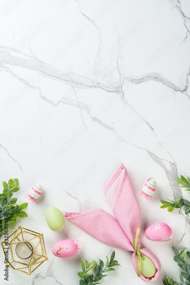 Easter composition with colored eggs and green plants on white background.