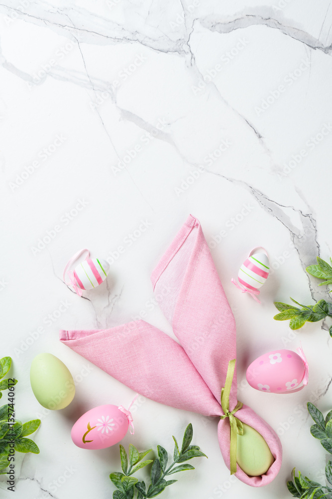 Easter composition with Bunny ears, colored eggs and green plants.