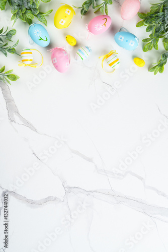 Easter composition with Bunny ears, colored eggs and green plants.