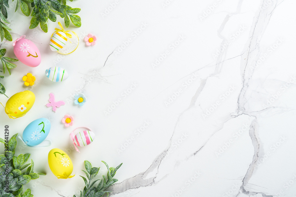 Easter composition with colored eggs and green plants on white background.