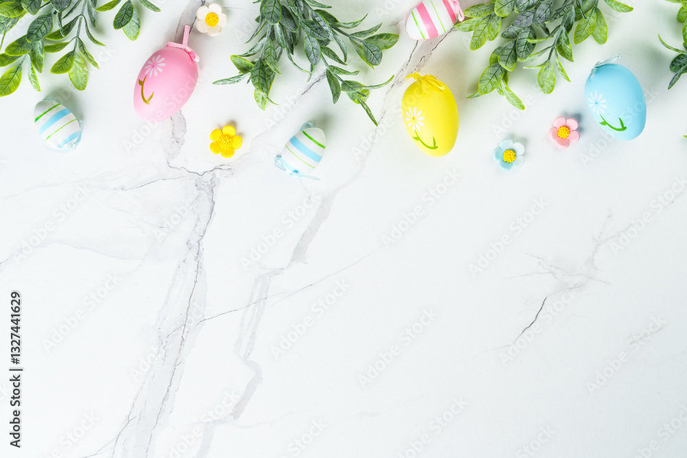 Easter composition with colored eggs and green plants on white background.
