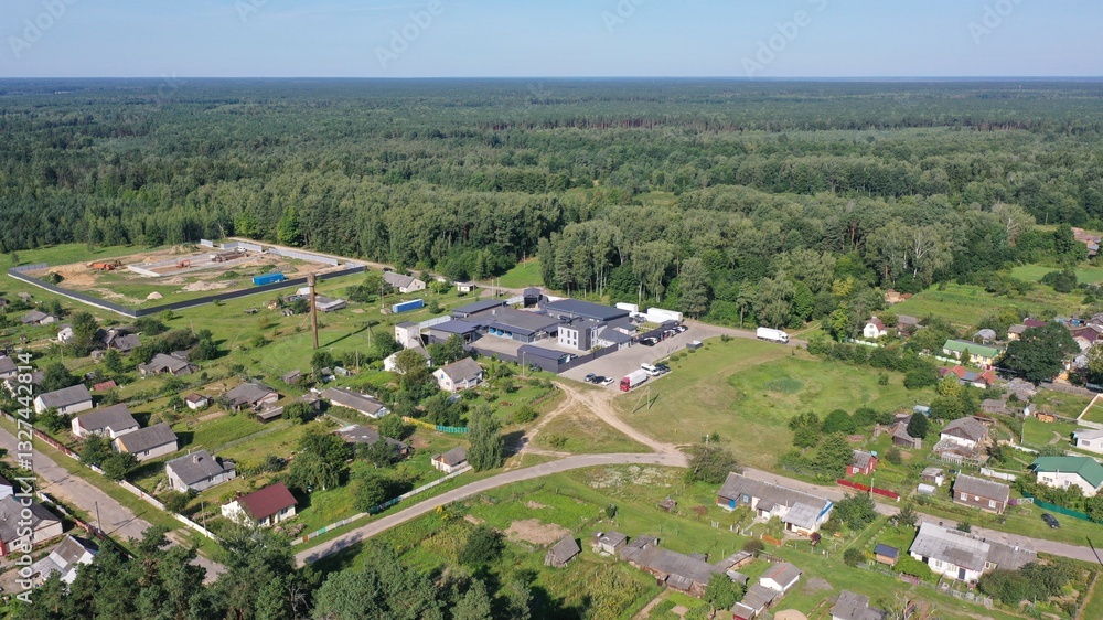 Rural settlement near a huge forest coniferous vastness in summer. A village on the edge of a huge forest. Harmony of man and nature. Rural settlement near a huge forest coniferous vastness in summer. A village on the edge of a huge forest. Harmony of man and nature.