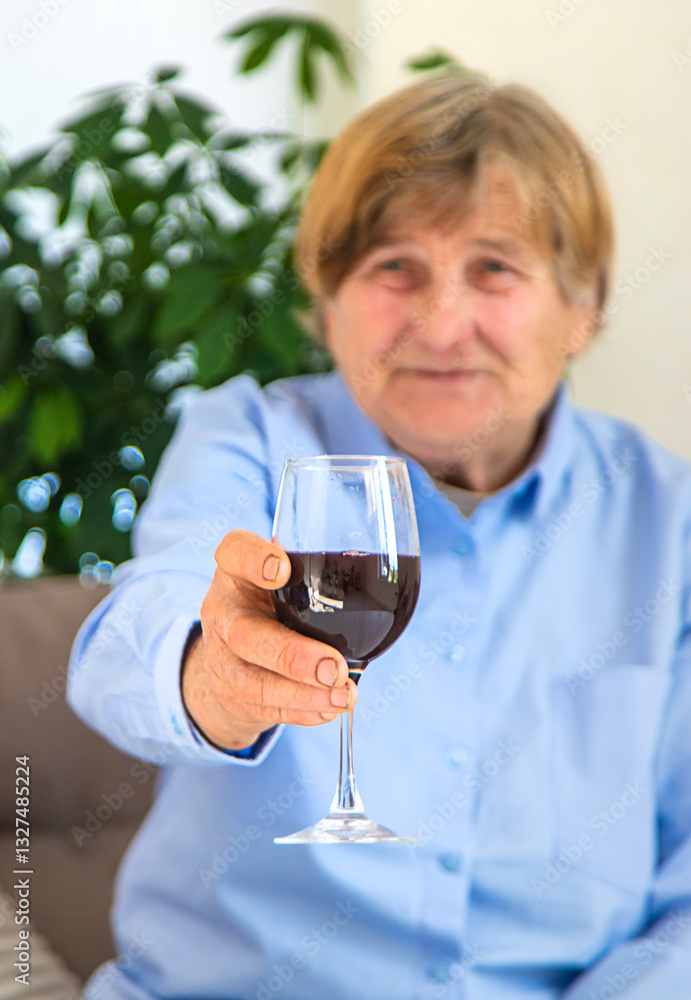 Old woman drinking wine. Selective focus. Old woman drinking wine. Selective focus.