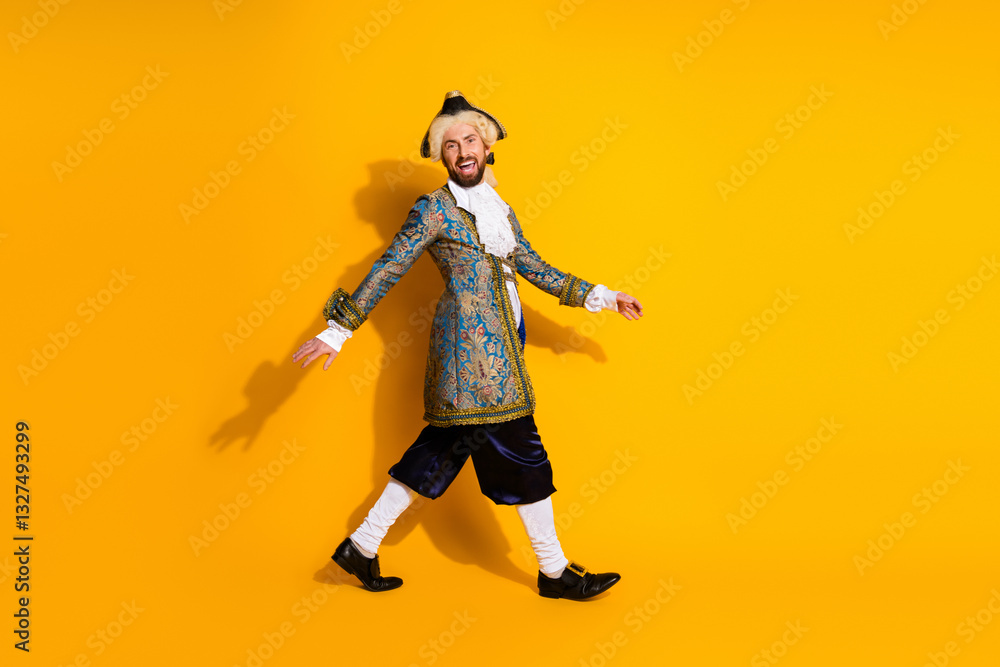 Young man dressed as a nobleman walks joyfully on a yellow background in retro attire Young man dressed as a nobleman walks joyfully on a yellow background in retro attire