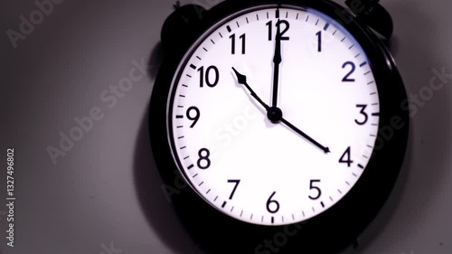 Time's Elegance: A close-up shot captures a classic alarm clock, hands precisely positioned, against a dim backdrop, evoking a sense of urgency, timelessness, and the subtle beauty of daily moments.