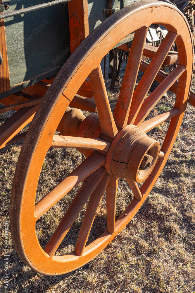 Spoked wooden wheel on an old chuck wagon.