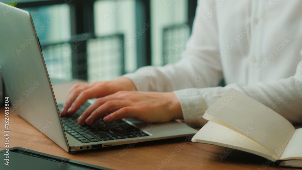 Hands of young businesswoman typing on laptop keyboard while sitting on desk . Hands of young businesswoman typing on laptop keyboard while sitting on desk .