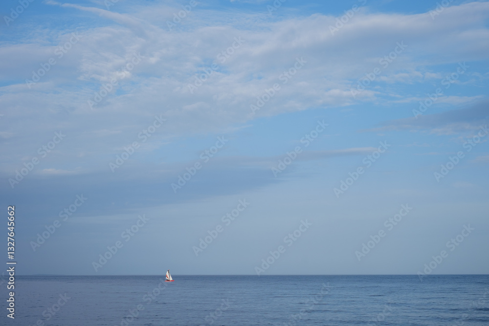 Fototapeta premium Sailboat in the distance in good weather on the lake.