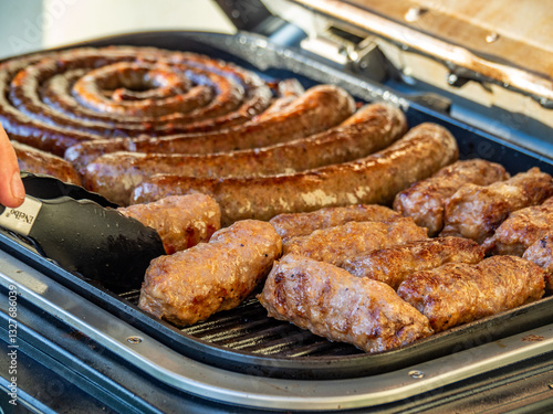 a closeup shot of sausages on a tray in a barbecue