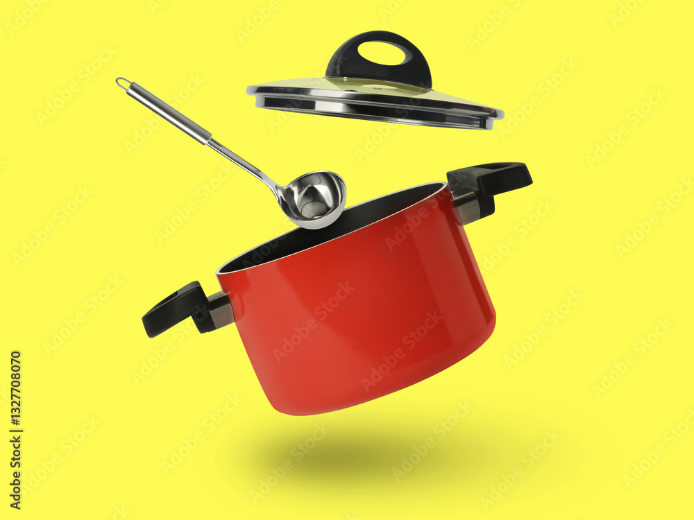Fototapeta premium Saucepan and ladle in air on yellow background