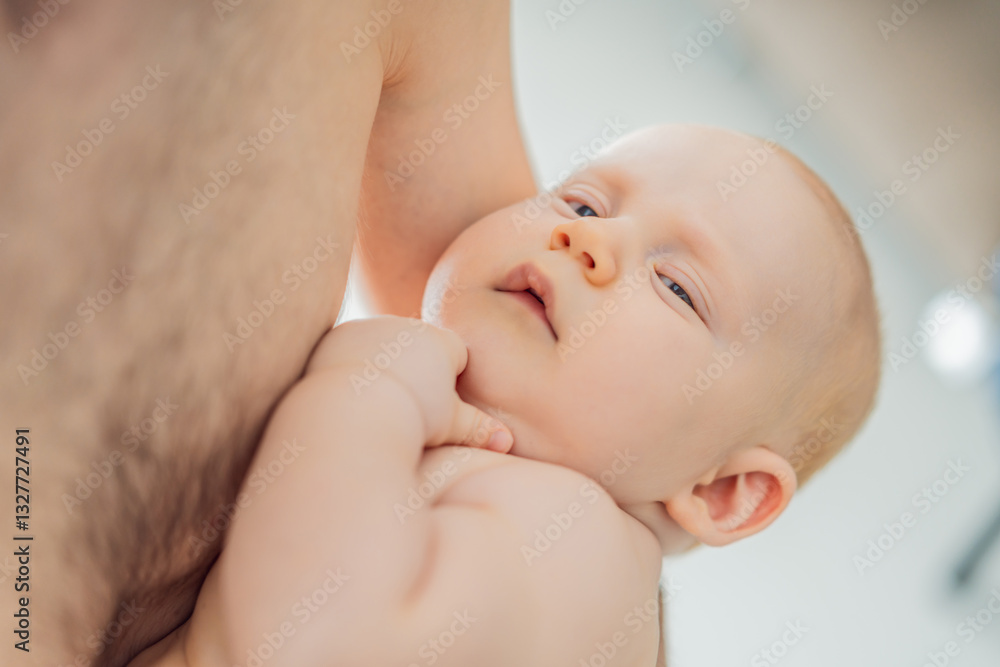 A baby peacefully falls asleep in his father's arms, skin-to-skin. A heartwarming and intimate moment of love, bonding, and parenthood, showcasing the deep connection between father and child