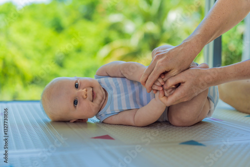 Obraz na płótnie A mother practices baby gymnastics with her 3-month-old on a soft children's play mat. A joyful and nurturing moment focused on bonding, development, and care. Early childhood, fitness, and parenting w salonie