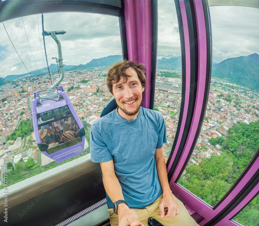 Male tourist riding a cable car in Orizaba, Mexico. Scenic aerial journey with breathtaking mountain and city views. Concept of adventure, eco-tourism, and exploration of Mexican landscapes