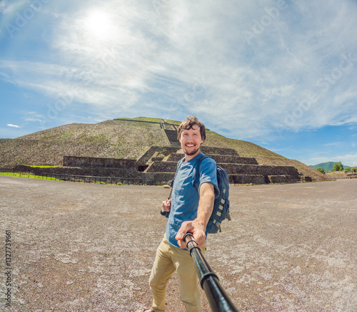 Obraz na płótnie Male tourist exploring Teotihuacan, Mexico. Solo traveler walking through ancient pyramids and ruins at sunrise. Concept of cultural heritage, archaeology, and Mexican tourism w salonie