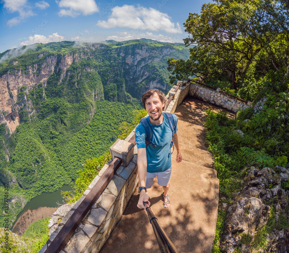 Male tourist exploring Sumidero Canyon National Park, Mexico. Adventurous traveler enjoying breathtaking views of cliffs and river in this iconic natural landmark. Concept of nature, exploration, and