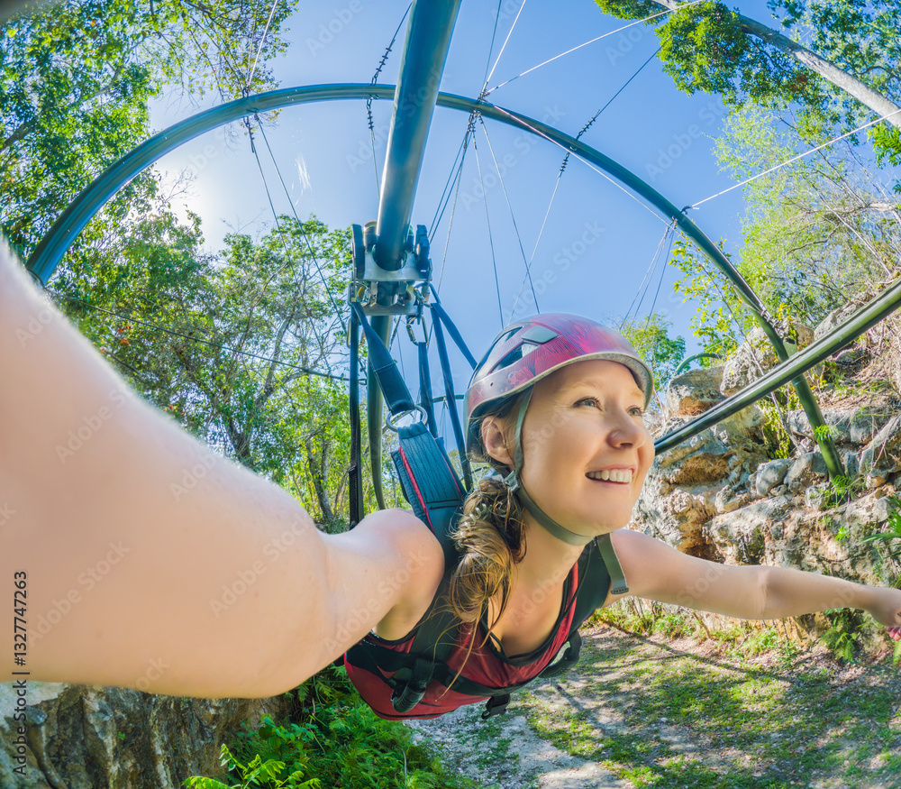 Woman in helmet flying on a zipline over a lush tropical park. Thrilling adventure surrounded by nature, perfect for eco-tourism and adrenaline seekers. Extreme sports and outdoor exploration concept