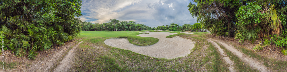 Scenic panorama of a tropical golf course surrounded by lush jungle. Serene landscape ideal for relaxation, sports, and luxury travel. Nature, recreation, and tropical getaway concept