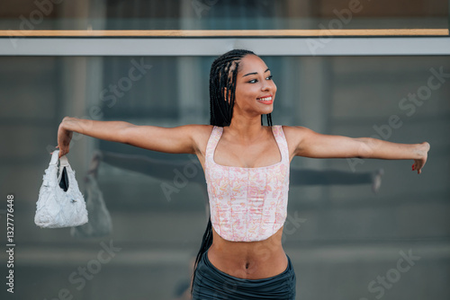 young woman or chica latina with open arms on the street feeling happy photo