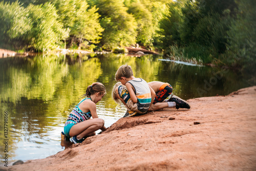 Kids playing on side of lake