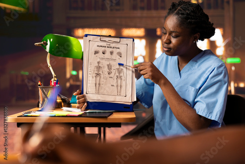 Tableau sur toile African American pupils studying together for med school exams, man and woman helping each other memorize healthcare details