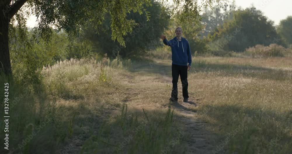 Happy Man Waves Hand While Walking on Nature in the Morning 4K 10-bit Happy Man Waves Hand While Walking on Nature in the Morning 4K 10-bit