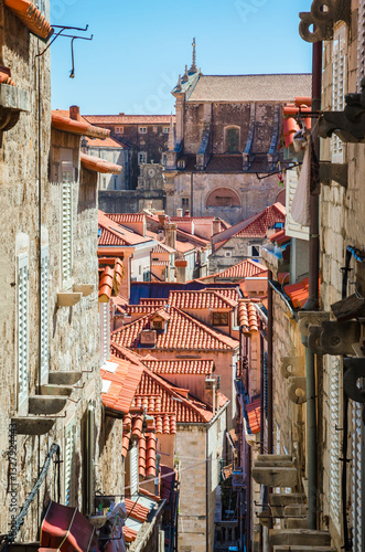 Famous narrow street and old city walls in Dubrovnik, Croatia