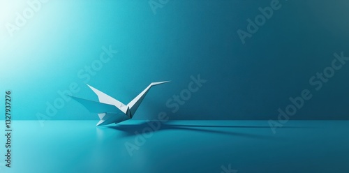 A white paper origami crane resting on a reflective teal surface