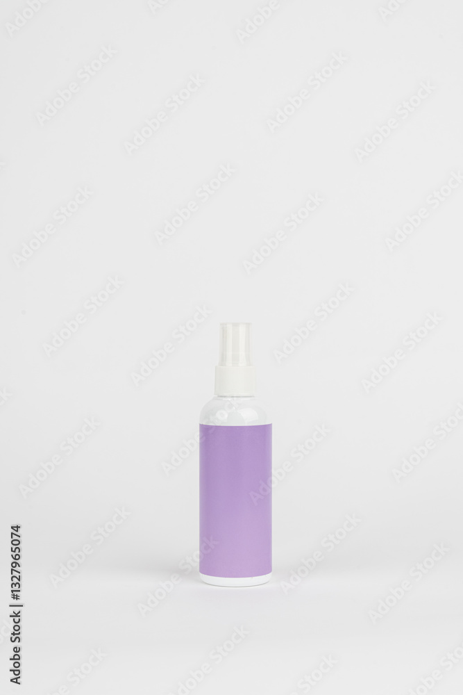 Minimalist White Spray Bottle with Purple Label on White Background Minimalist White Spray Bottle with Purple Label on White Background