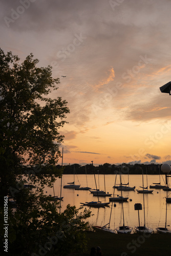 Slika na platnu A breathtaking sunset over Lake Bde Maka Ska in Minneapolis, reflecting vibrant colors on the water