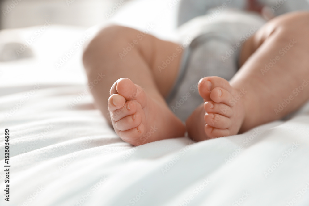 Little baby lying on bed indoors, closeup Little baby lying on bed indoors, closeup