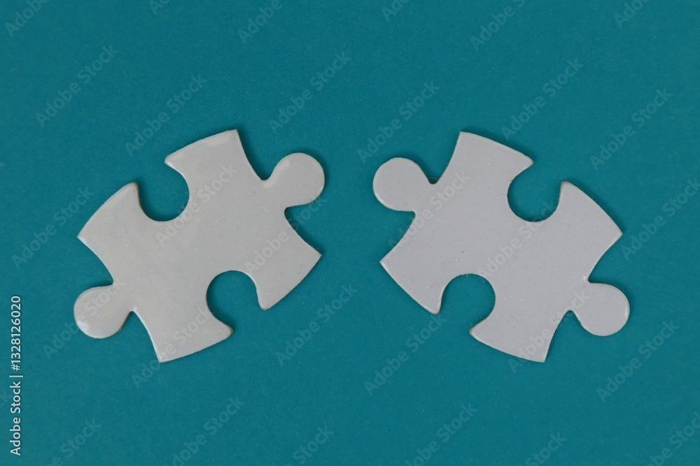 Obraz premium Two white puzzles with a blue background