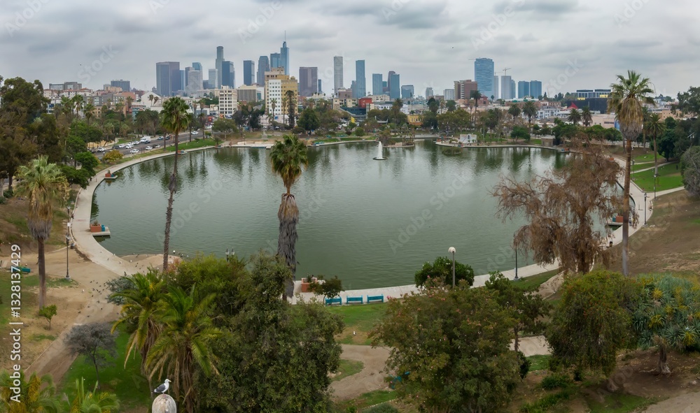 Fototapeta premium Macarthur Park in Los Angeles, California, USA. A scenic view of the park's lake and the city skyline. People are enjoying the park's amenities, walking, and relaxing.