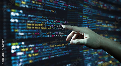 Human hand pointing at the abstract Modern tech of Programming code screen developer. C Programming Language of Computer script and Technology background of software.